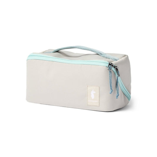 Front view of the Cotopaxi Viaje Toiletry Kit in Cotopaxi Black with a light blue zipper and handle against a white background.