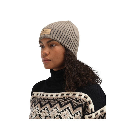 A woman wears the Dale Of Norway Alvøy Hat-SAMPLE in MtnStone Navy, shown from the side against a white background.