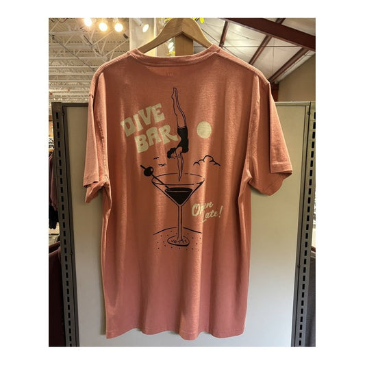 Back view of the Jetty Men's Dive Bar Tee in Mauve showing a dive bar graphic on the back against a store background.