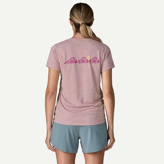 Back view of the Patagonia Women's Cap Cool Daily Shirt - TrailCheck in Quiet Violet on a model wearing blue shorts against a white background.