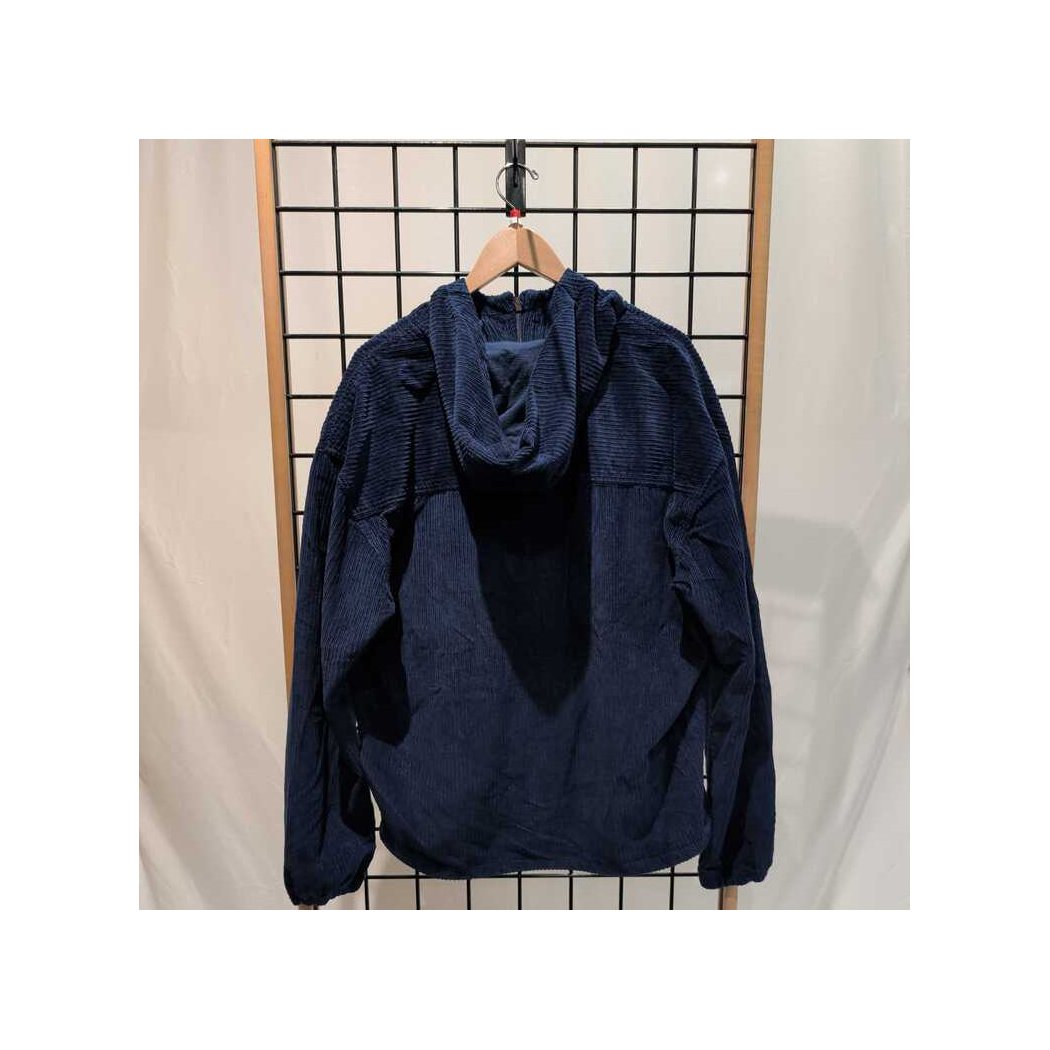 Back view of the Prana Mens Durado Cord Anorak-SAMPLE in Capulet Blue hanging on a grid display with a wooden hanger.
