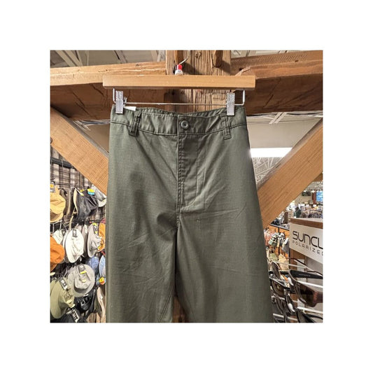 Front view of the Prana Mens Palisades Ripstop Chino Pant-SAMPLE in Nori/32 hanging on a wooden hanger with a hat display in the background.