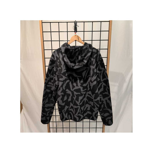 Back view of the Prana Mens Tuff Fluff Full Zip-SAMPLE in Shadow Freestyl hanging on a wooden hanger against a grid background.