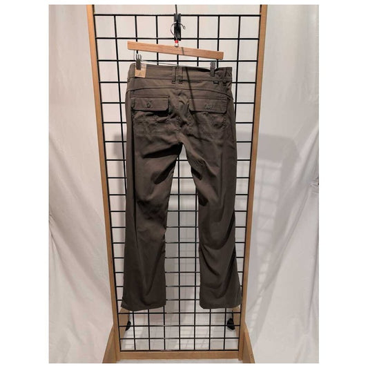 Back view of the Prana Womens Halle Pant-SAMPLE in Slate Green hanging on a grid display with a wooden frame.