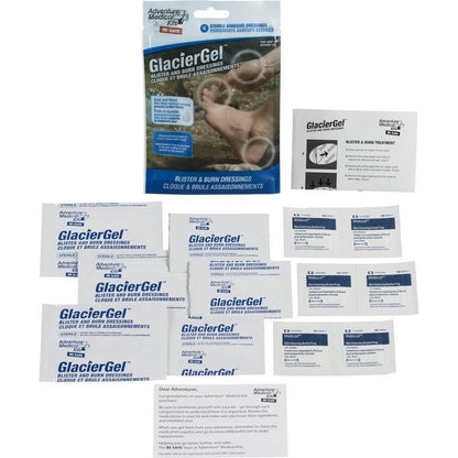 A package of Adventure Medical Kits GlacierGel Blister and Burn Dressing with multiple individual packets laid out below it.