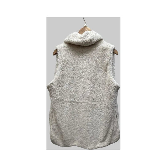 Back view of the Aventura Womens Cozy Fleece Vest in Egret hanging on a wooden hanger against a gray background.