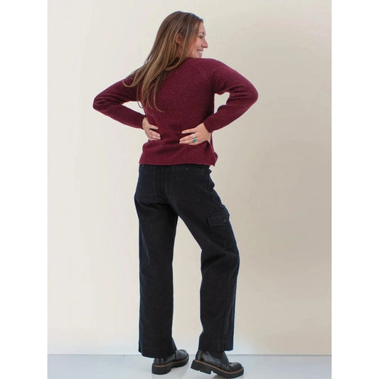 Back view of the Aventura Womens Mable Sweater in Port Royale on a model with hands on hips against a plain background.