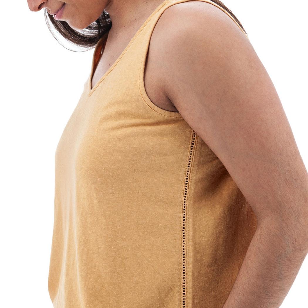 Side view of the Aventura Women's Simone Tank Top in Amber Gold showing the side seam detail against a white background.