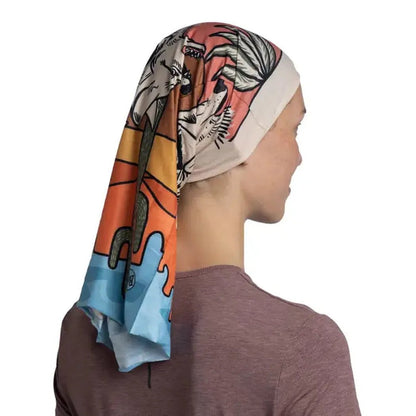 Side view of the Buff CoolNet UV - Amino bandana on a model wearing a charcoal shirt against a white background.