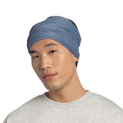 A front view of the Buff Original EcoStretch - Solid Water bandana on a model wearing a gray shirt against a white background.