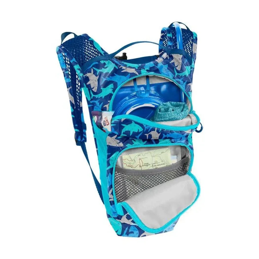 A front view of the CamelBak Mini Mule 1.5L in Sharks showing the hydration reservoir and front pocket against a white background.