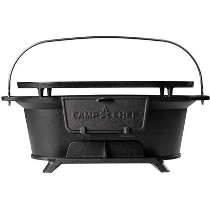 Back view of the Camp Chef Cast Iron Charcoal Grill with a black handle and stand against a white background.