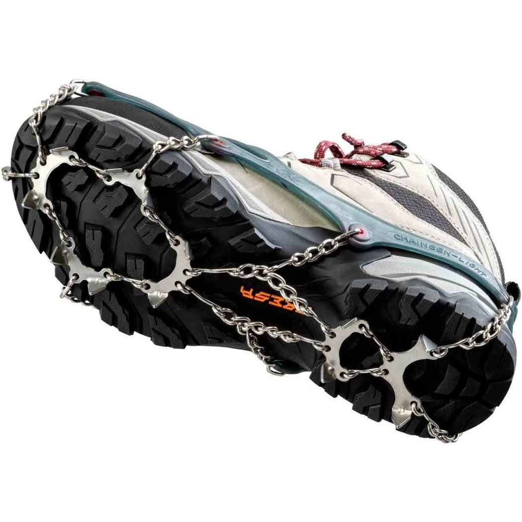 Close-up of the CAMP Spikes Light attached to a shoe showing the metal chain and spikes on the outsole.