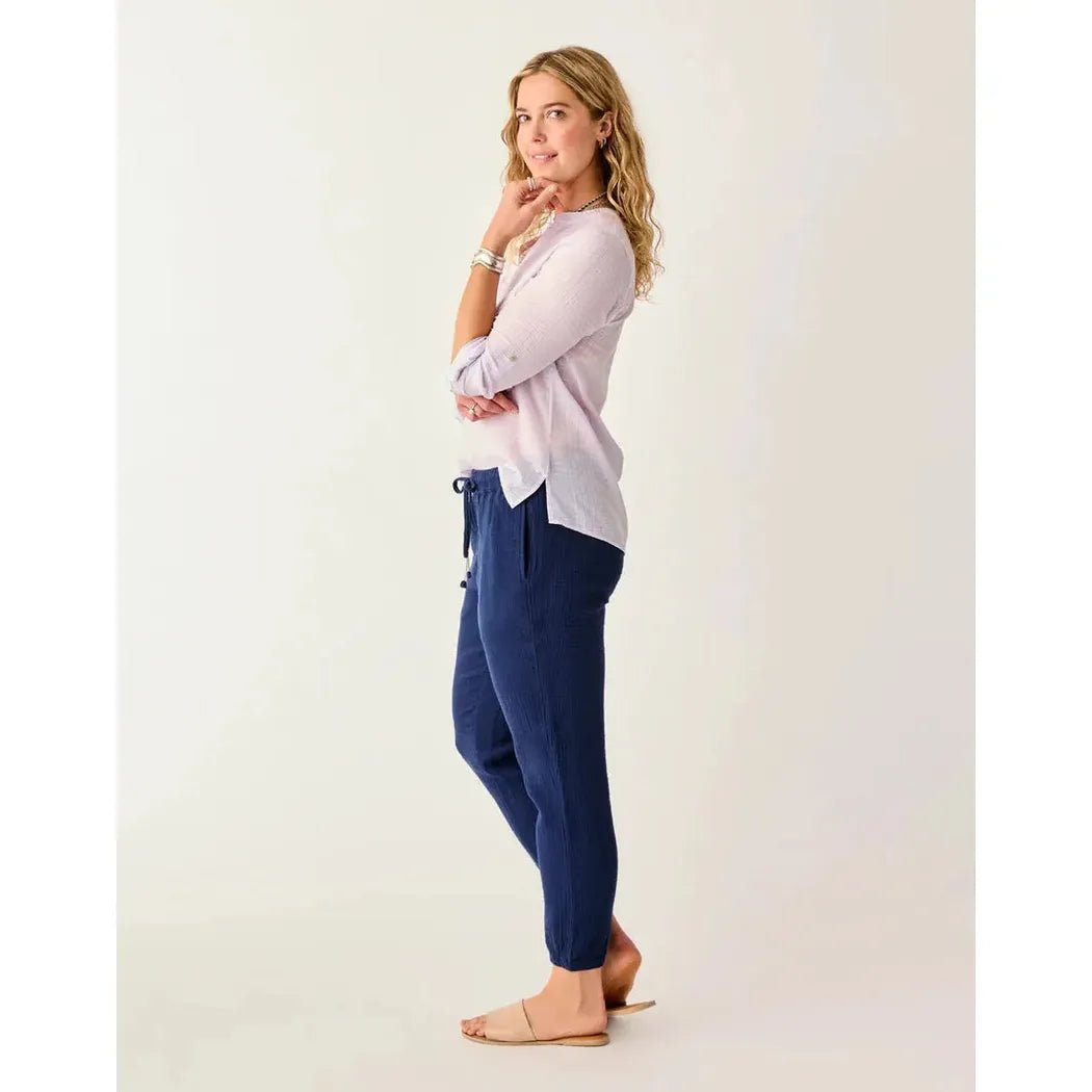 Side view of the Carve Designs Women's Calista Gauze Pant in Navy showing the drawstring waist and model wearing it against a white background.