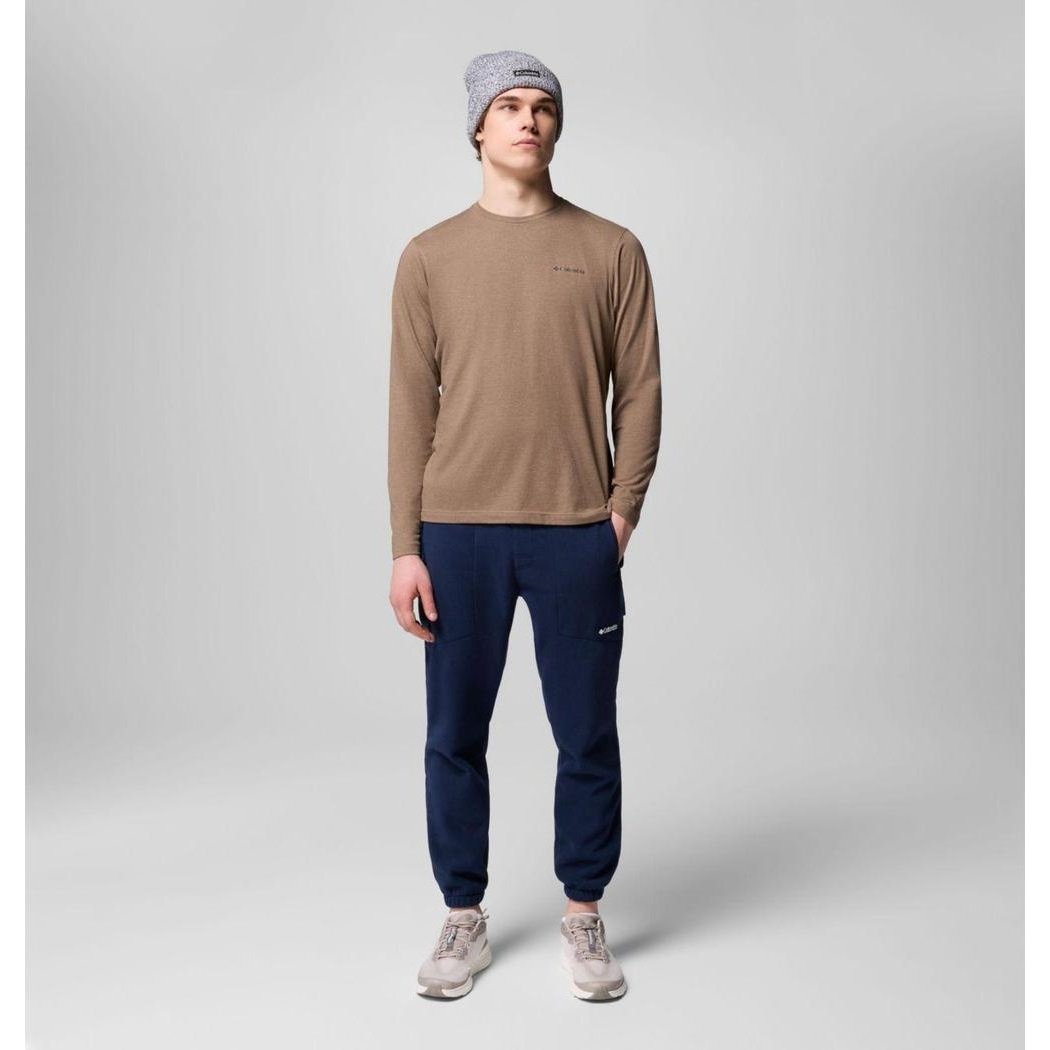 A model wearing Columbia Sportswear Men's Sequoia Grove Pants in Collegiate Navy stands against a plain gray background.