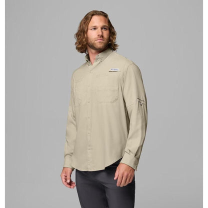 A man wearing the Columbia Sportswear Men's Tamiami II Long-Sleeve Shirt in Fossil stands against a gray background.
