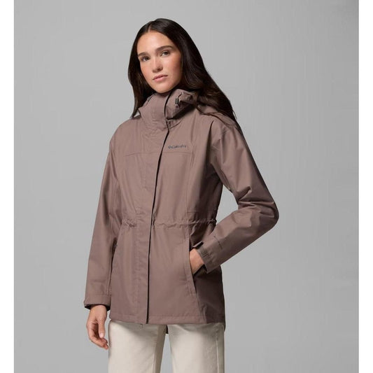 A woman models the Columbia Sportswear Women's Hikebound II Long Jacket in Iron, showing the front with a high collar and pockets, against a plain gray background.