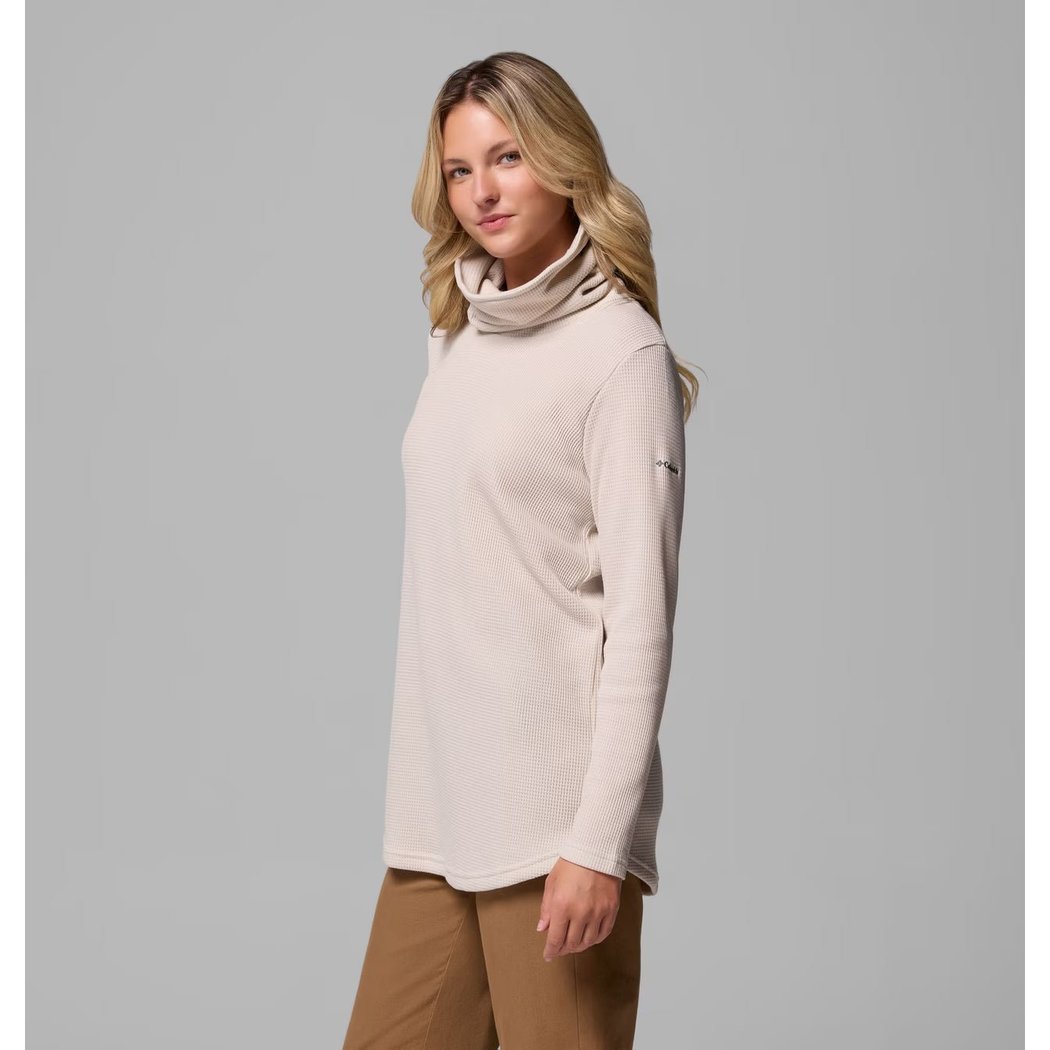 Side view of the Columbia Sportswear Women's Holly Hideaway Waffle Cowl Neck Pullover in Dark Stone on a model against a gray background.