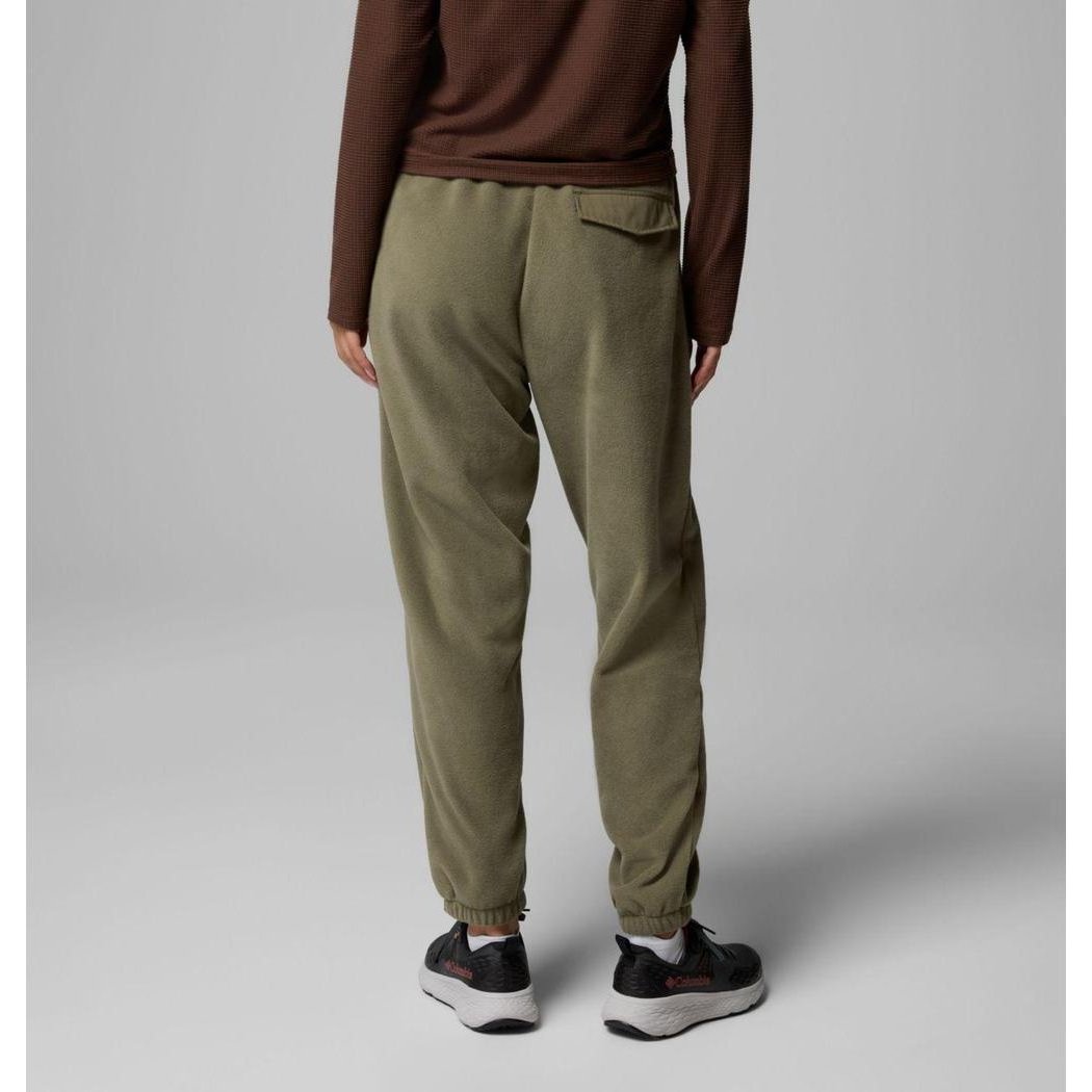 Back view of the Columbia Sportswear Women's Sequoia Grove Fleece Pants in Stone Green on a model wearing black sneakers against a gray background.