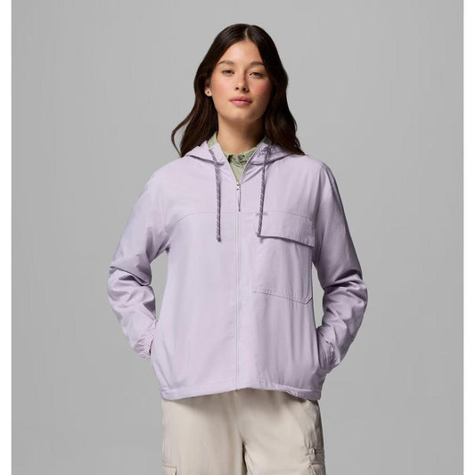 A model wearing the Columbia Sportswear Women's Skien Valley Hooded Long Sleeve Shirt in Lavender Pearl stands against a gray background.