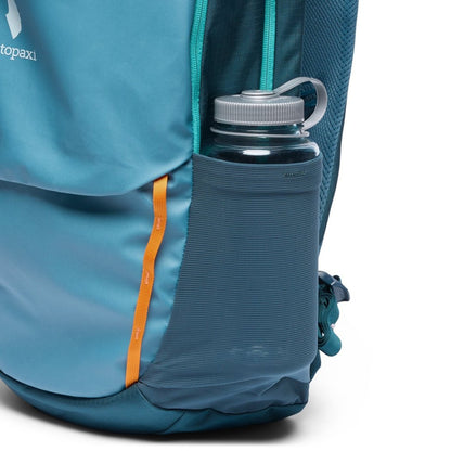 Close-up of the Cotopaxi Allpa 26L Daypack in Blue Spruce/Abyss showing the side water bottle pocket and orange zipper pull.