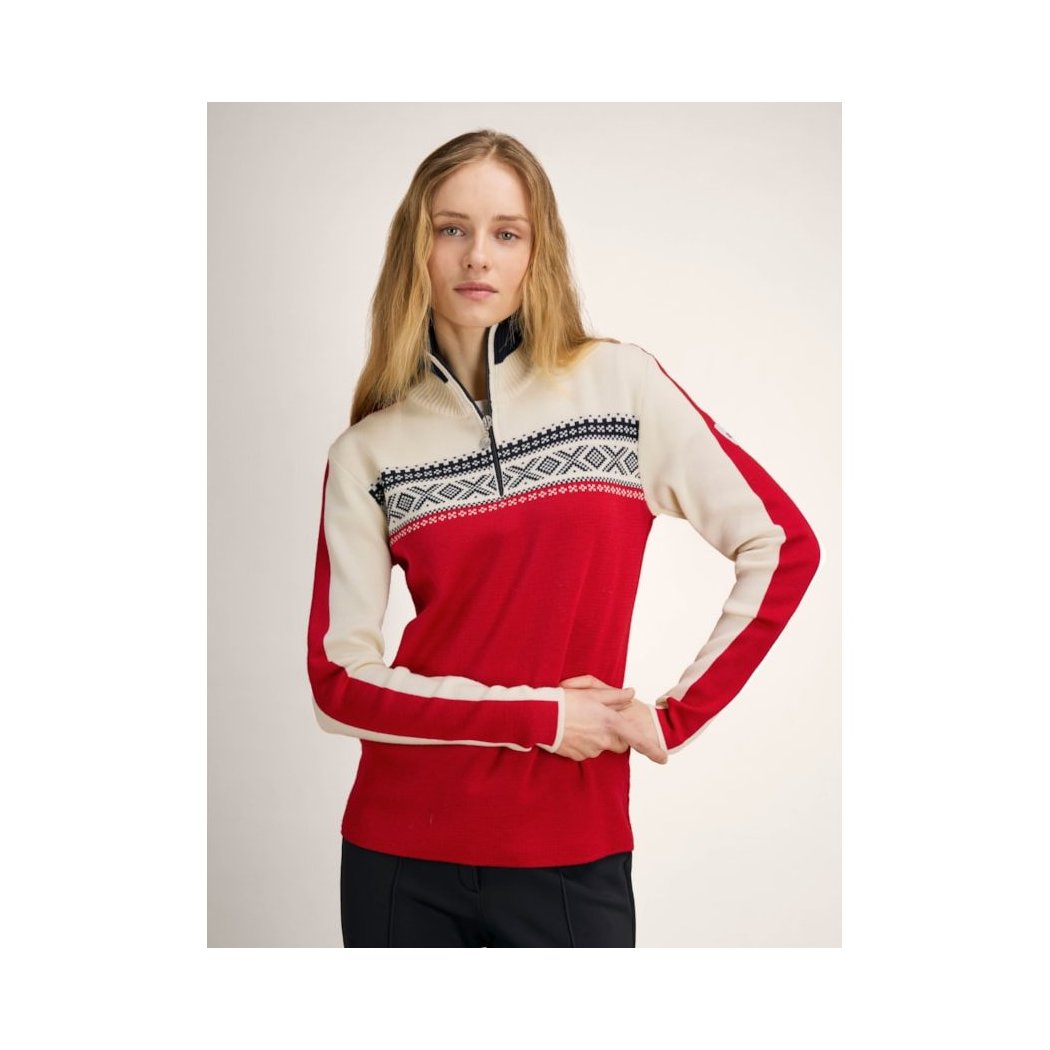A woman wearing the Dale Of Norway Dystingen Fem Sweater-SAMPLE in RaspOffWhtNavy poses against a plain background.
