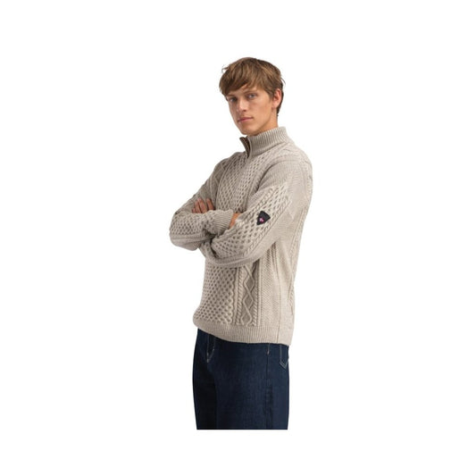 Side view of the Dale Of Norway Jordalen Masc. Sweater-SAMPLE in Sand Melange showing the cable knit pattern and model wearing it against a white background.
