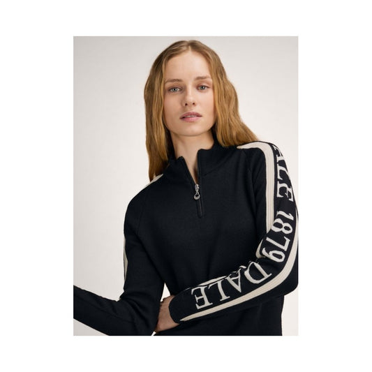 A model wears the Dale Of Norway Skarstind 1879 Feminine Sweater-SAMPLE in BlackOffWhite with a white background.