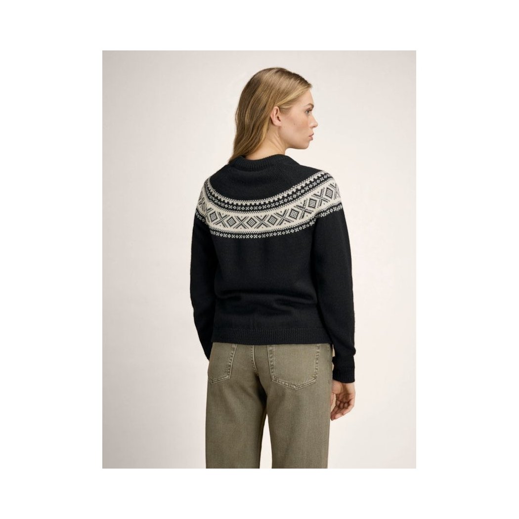 Back view of the Dale Of Norway Vågsøy Feminine Sweater-SAMPLE in Black Offwhite on a model wearing khaki pants against a plain background.