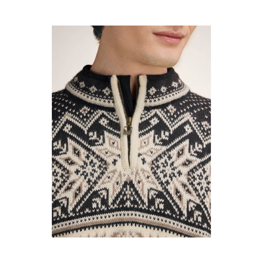 A close-up of a man wearing the Dale Of Norway Vail Masc Sweater-SAMPLE with a half-zip and intricate pattern against a plain background.