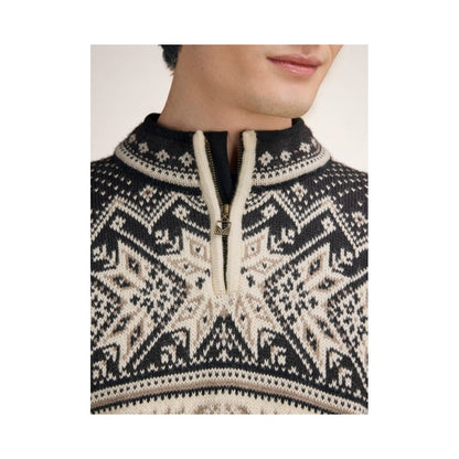 A close-up of a man wearing the Dale Of Norway Vail Masc Sweater-SAMPLE with a half-zip and intricate pattern against a plain background.