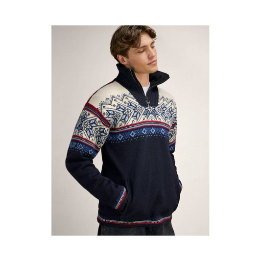 A model wears the Dale Of Norway Vail Windproof Masc Sweater-SAMPLE in NavyRedOffWht with a high collar and patterned chest and sleeves.