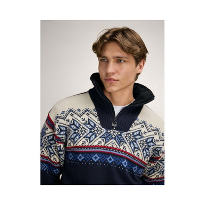 A front view of the Dale Of Norway Vail Windproof Masc Sweater-SAMPLE with a navy, red, and off-white pattern on a model wearing it against a light background.