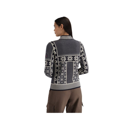 Back view of the Dale Of Norway Vardåsen Fem. Sweater-SAMPLE showing the patterned design on a model wearing brown pants against a white background.