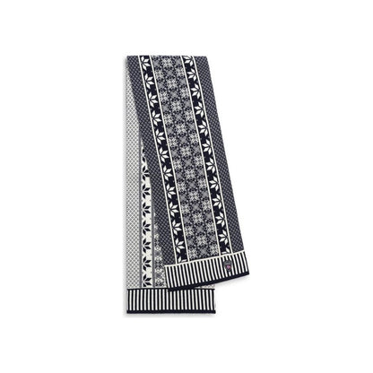 A folded Dale Of Norway Vardåsen Scarf-SAMPLE in UltramarineoffW with a patterned design and striped ends, photographed against a white background.