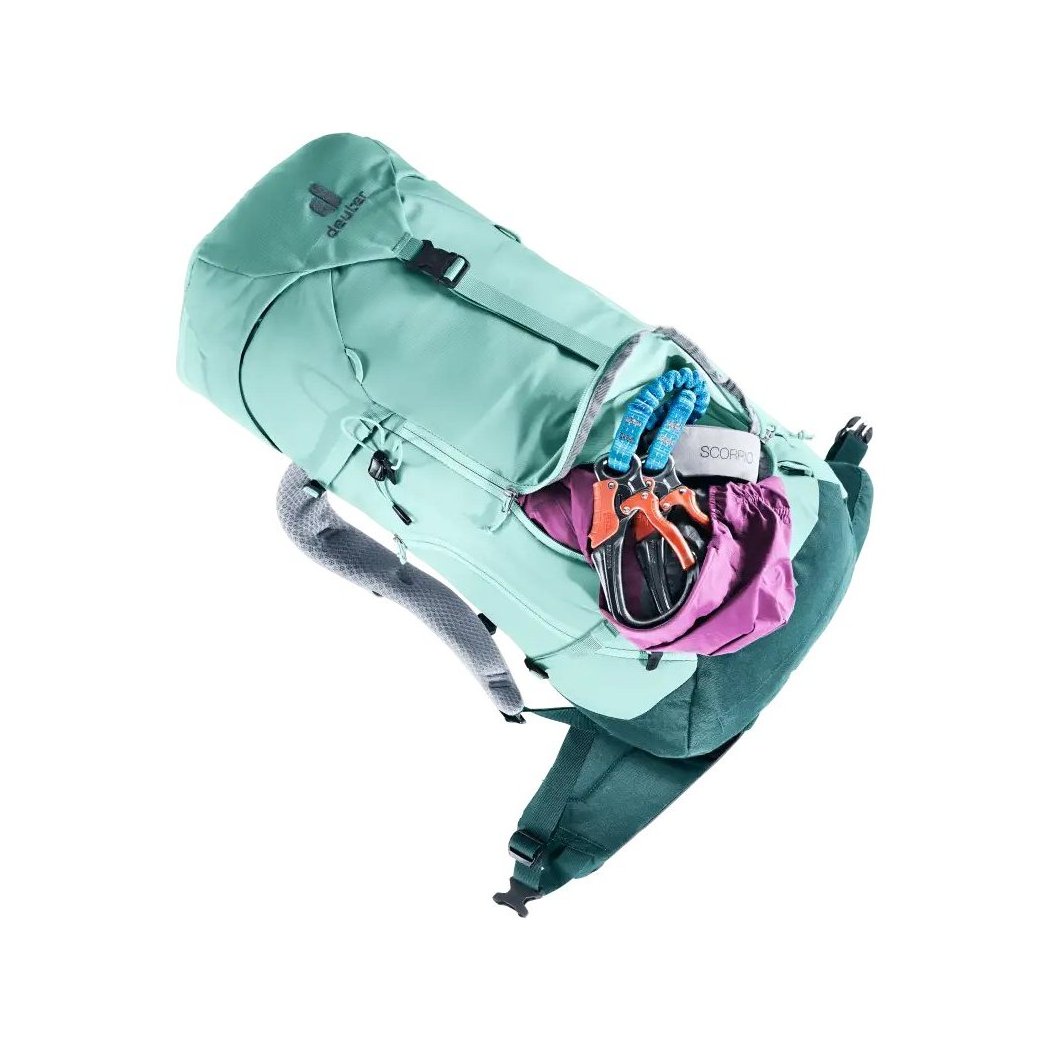 Side view of the Deuter Trail 28 SL in Glacier Deep Se showing the open main compartment with climbing gear inside against a white background.