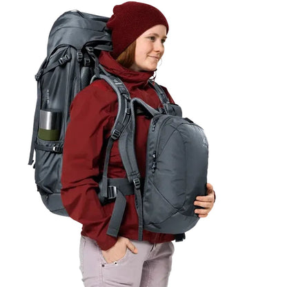 Side view of the Deuter Voyager 60+10 SL backpack in Black showing the large main compartment and a model wearing it against a white background.