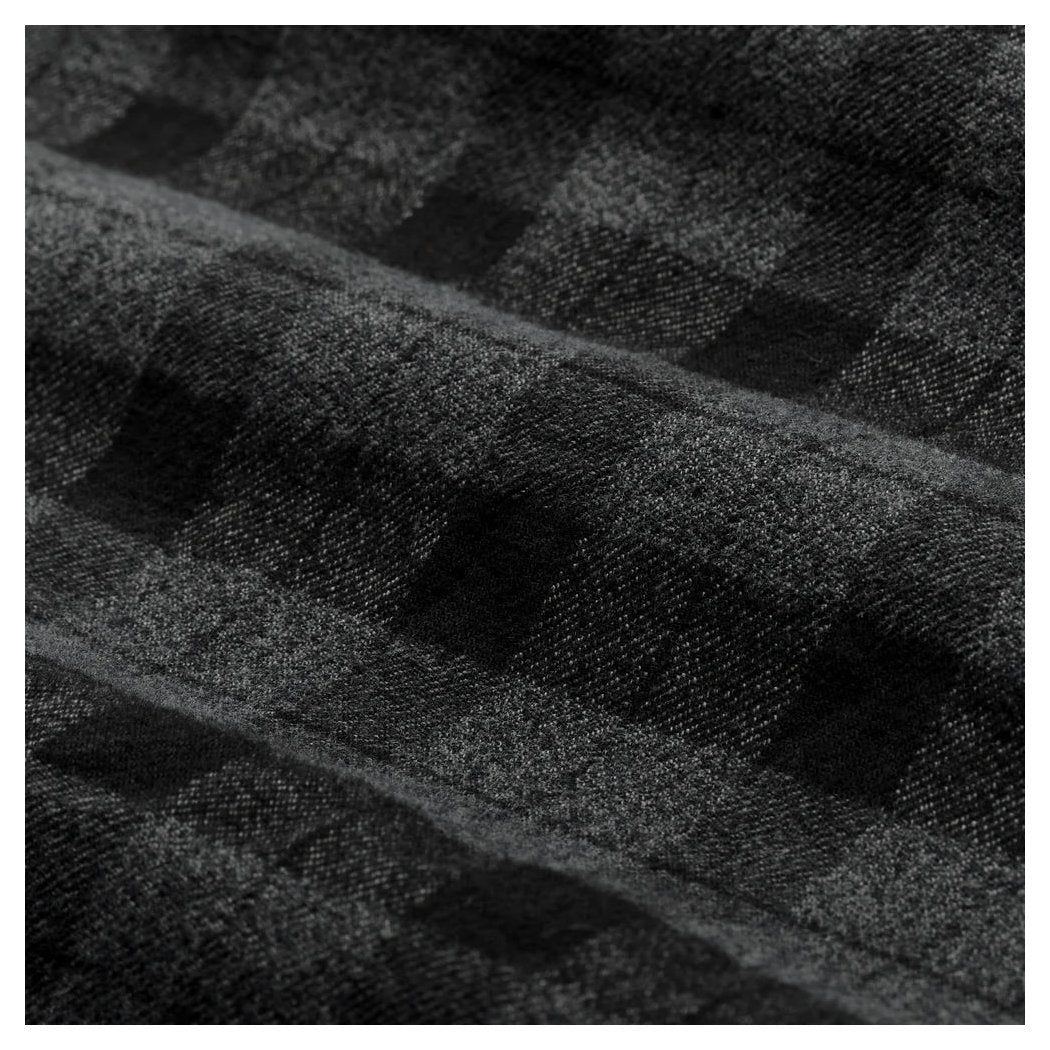 Close-up of the Filson Men's Alaskan Guide Shirt in Heath Blk Plaid showing its plaid pattern and fabric texture.