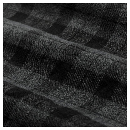 Close-up of the Filson Men's Alaskan Guide Shirt in Heath Blk Plaid showing its plaid pattern and fabric texture.