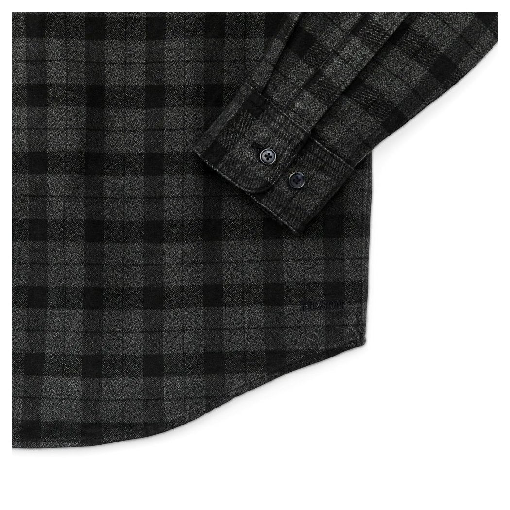 Close-up of the Filson Men's Alaskan Guide Shirt in Heath Blk Plaid showing the buttoned cuff and plaid pattern.