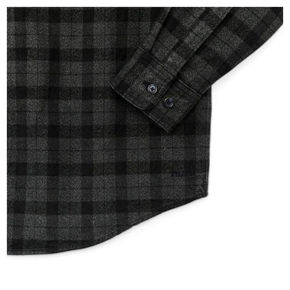 Close-up of the Filson Men's Alaskan Guide Shirt in Heath Blk Plaid showing the buttoned cuff and plaid pattern.