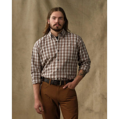 Front view of the Filson Men's Chambray Button-Down Shirt in Cascade PLaid with a model wearing it against a tan backdrop.