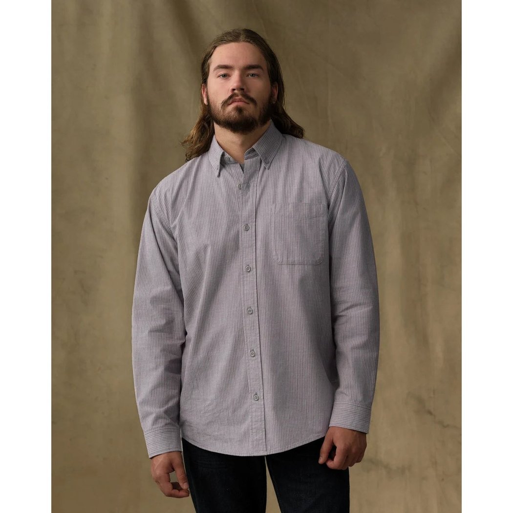 Front view of the Filson Men's Chambray Button-Down Shirt in Cascade PLaid on a model against a tan backdrop.
