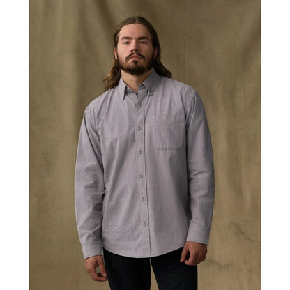 Front view of the Filson Men's Chambray Button-Down Shirt in Cascade PLaid on a model against a tan backdrop.