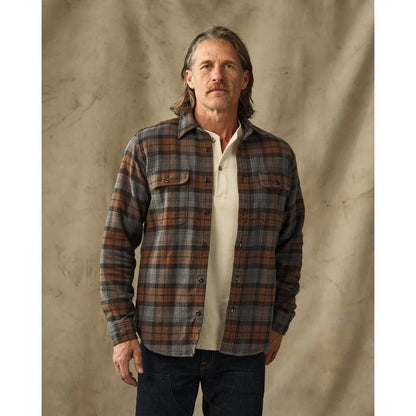 Front view of the Filson Men's Vintage Flannel Work Shirt in Brown with a model wearing it against a neutral background.