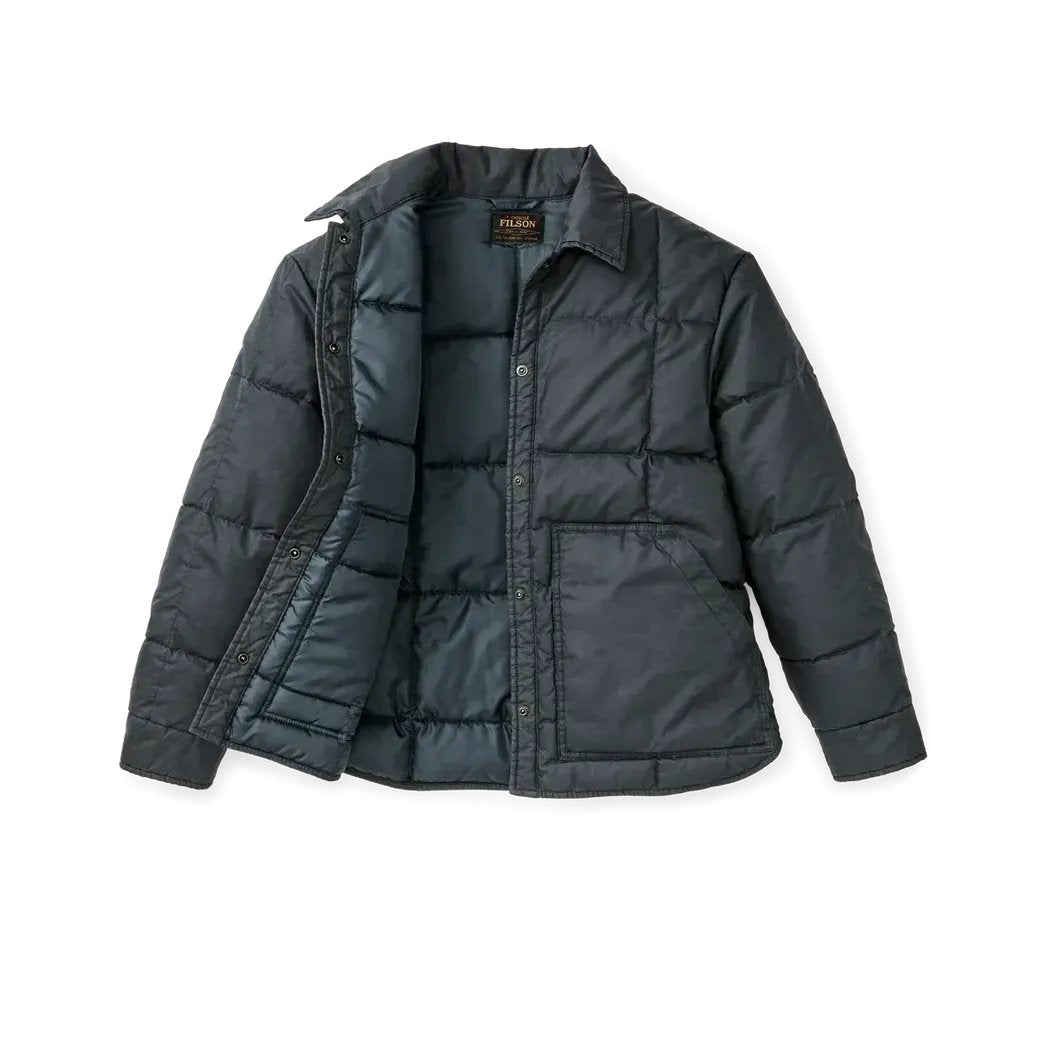 A front view of the Filson W's Heritage Cotton Down Jacket in Bluefin showing the front pocket and button closure against a white background.