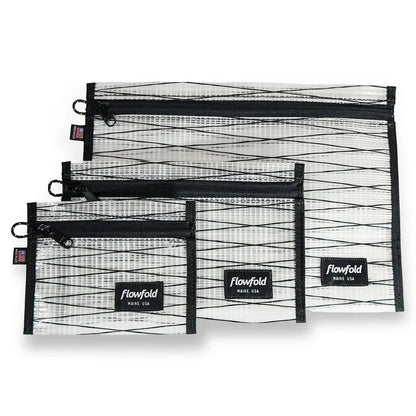 Three black sailcloth Flowfold zipper pouches in varying sizes are displayed against a white background.