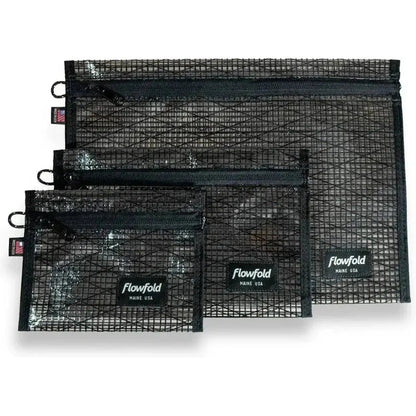 Three black Flowfold recycled sailcloth zipper pouches in varying sizes are displayed against a white background.