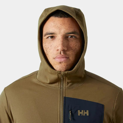 A front view of the Helly Hansen Men's Versalite Hooded Fleece Jacket in Sepia with a dark blue pocket patch and zipper, on a model against a plain white background.