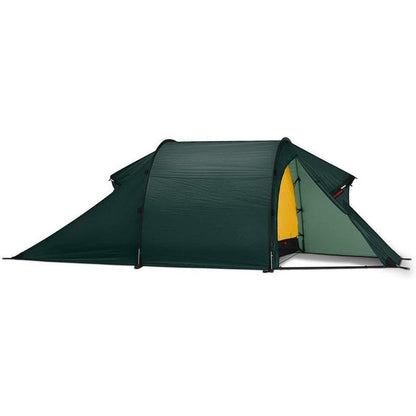 Side view of the Hilleberg Nammatj 3 green tent showing the entrance and a white background.